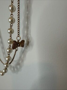 Layered Cream Pearl Style Necklace with Gold-Tone Chain with Bow Accents